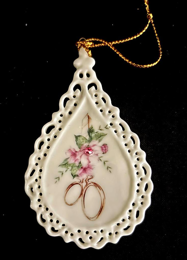 Courtly Quilter tear drop ceramic ornament with lace edging, decorative gold scissors, flowers and crystal