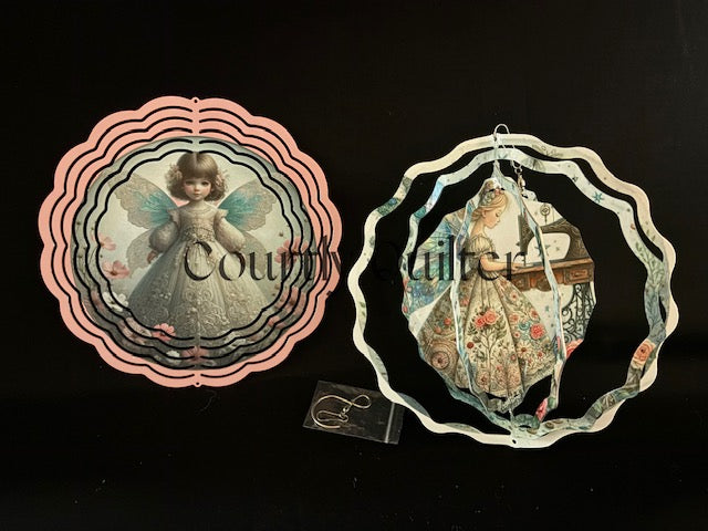 Courtly Quilter fairy on one side, sewing fairy with vintage sewing machine on other side of wind spinner