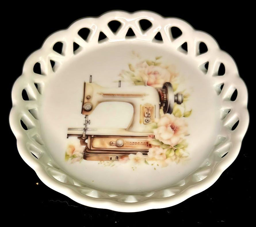 Decorative ceramic coaster with a sewing machine and floral design on a black background