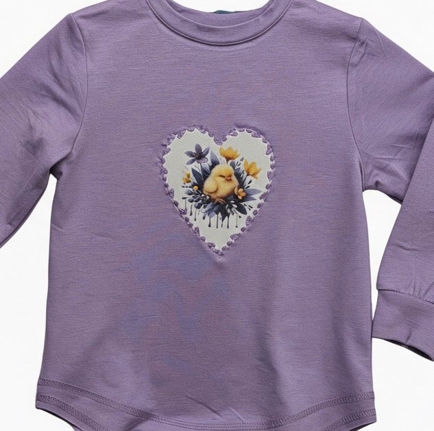 Purple sweatshirt with applique design of bird and flowers