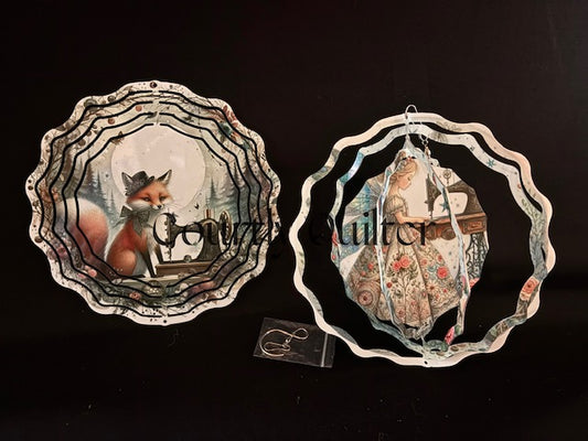 Courtly Quilter design with fox and sewing machine on one side, sewing fairy on other side of wind spinner