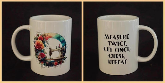 Courtly Quilter ceramic mug with white sewing machine and multi color flowers and wreath, quote "measure twice, cut once, curse, repeat"