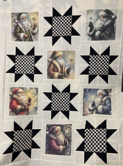 Quilt with star patterns and images of Courtly Quilter Santa Claus on a white background
